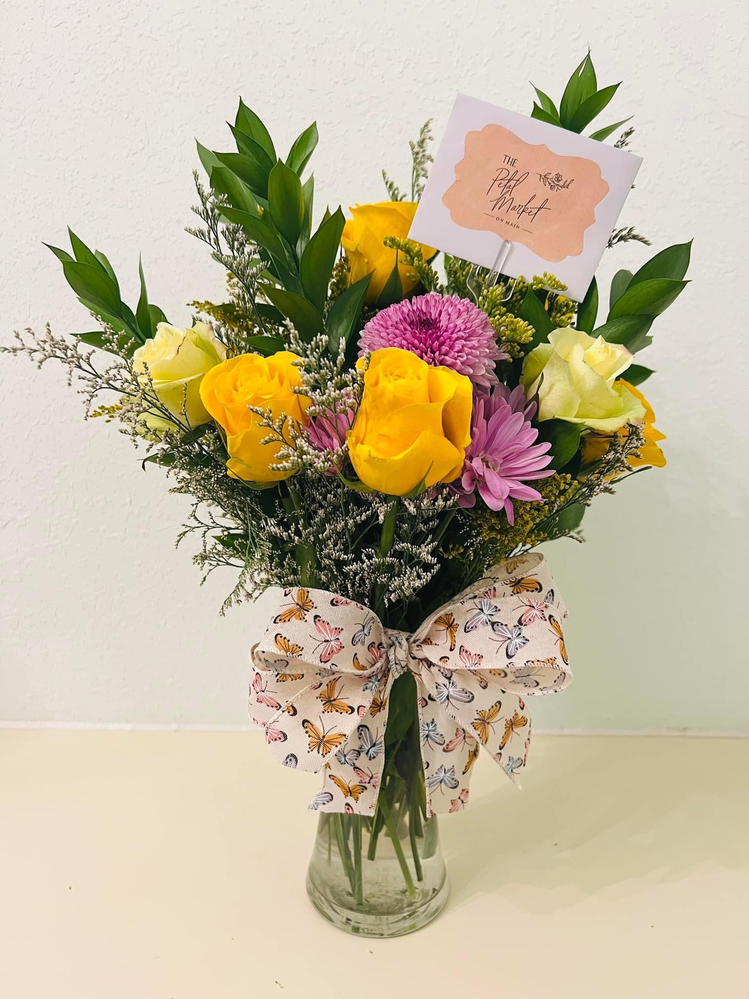 Seasonal arrangement of garden roses and greenery